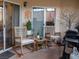 Outdoor patio with comfortable rocking chairs, a grill, and sliding glass door access at 2050 W Warm Springs Rd # 411, Henderson, NV 89014