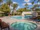 Community pool area with a hot tub, pool, lounge chairs, and umbrellas at 2050 W Warm Springs Rd # 411, Henderson, NV 89014