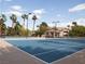 Blue and tan community tennis court with palm trees and nice landscaping at 2050 W Warm Springs Rd # 411, Henderson, NV 89014