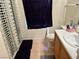 Functional bathroom featuring a vanity sink, toilet, tiled floor, and shower with decorative shower curtain at 2130 Dragonslayer Ave, Las Vegas, NV 89183
