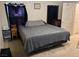 A cozy bedroom featuring neutral tones, a comfortable bed, and window with dark curtains at 2130 Dragonslayer Ave, Las Vegas, NV 89183