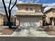 A cozy two-story house with a two-car garage and a red tile roof at 2130 Dragonslayer Ave, Las Vegas, NV 89183