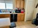 Practical kitchen with light wood cabinets, black appliances, and a double basin sink at 2130 Dragonslayer Ave, Las Vegas, NV 89183