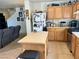 Open concept kitchen with wood cabinets, a center island, and a view into the living room at 2130 Dragonslayer Ave, Las Vegas, NV 89183