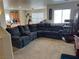 Cozy living room featuring plush sectional sofa, media center, and lots of natural light at 2130 Dragonslayer Ave, Las Vegas, NV 89183