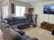 Inviting living room featuring a sectional sofa, display shelving, and warm lighting at 2130 Dragonslayer Ave, Las Vegas, NV 89183