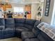 Open living space featuring sectional sofa, kitchen with island, and breakfast nook with natural light at 2130 Dragonslayer Ave, Las Vegas, NV 89183
