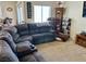 Inviting living room featuring a sectional sofa, display shelving, and warm lighting at 2130 Dragonslayer Ave, Las Vegas, NV 89183