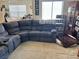 Cozy living room featuring plush sectional sofa, and lots of natural light at 2130 Dragonslayer Ave, Las Vegas, NV 89183