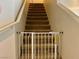 Carpeted staircase with a safety gate installed at the bottom at 2130 Dragonslayer Ave, Las Vegas, NV 89183