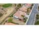 Aerial view of a single-Gathering home with tile roof and lush backyard artificial turf backing to a golf course at 2257 Lauren Dr, Las Vegas, NV 89134