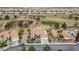 Bird's eye view of a single-Gathering home with tile roof backing to a golf course with desert landscaping and mature trees at 2257 Lauren Dr, Las Vegas, NV 89134