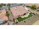 Aerial view of a tile roof single-Gathering home with lush desert landscaping and an artificial turf backyard at 2257 Lauren Dr, Las Vegas, NV 89134