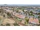 Expansive aerial view of a desert community with mature landscaping, golf course, tennis courts, and stunning mountain views at 2257 Lauren Dr, Las Vegas, NV 89134