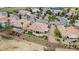 Aerial view of a single-Gathering home with patio and artificial turf and lush desert landscaping near a golf course at 2257 Lauren Dr, Las Vegas, NV 89134