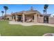 A beautiful backyard features artificial turf, a patio, and comfortable seating, all within a private, landscaped space at 2257 Lauren Dr, Las Vegas, NV 89134