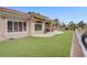 This home has a beautifully landscaped backyard with artificial turf, a patio, and views of the golf course at 2257 Lauren Dr, Las Vegas, NV 89134