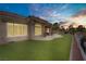 Expansive backyard featuring a covered patio and manicured artificial lawn providing the perfect outdoor retreat at 2257 Lauren Dr, Las Vegas, NV 89134