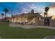 Inviting backyard features an expansive patio, lush artificial turf, and desert landscaping for relaxed outdoor living at 2257 Lauren Dr, Las Vegas, NV 89134