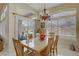 Charming dining room with abundant natural light, a stylish chandelier, and comfortable seating for six at 2257 Lauren Dr, Las Vegas, NV 89134