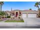 Charming desert home features lush landscaping, a red tile roof, a two-car garage, and a neatly manicured front lawn at 2257 Lauren Dr, Las Vegas, NV 89134