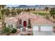 Beautiful desert home with a red tile roof, a two-car garage, palm trees and desert landscaping at 2257 Lauren Dr, Las Vegas, NV 89134