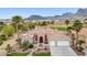 Landscaped front yard with palm trees enhances this charming desert home with a red tile roof and two-car garage at 2257 Lauren Dr, Las Vegas, NV 89134
