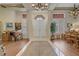 Grand foyer features an elegant chandelier, high ceilings, wood floors, and a clear view to the double door entry at 2257 Lauren Dr, Las Vegas, NV 89134