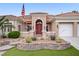 Inviting front entrance with lush landscaping and a charming courtyard leading to an elegant red double door at 2257 Lauren Dr, Las Vegas, NV 89134