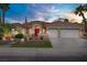 Inviting single-story home with well-maintained desert landscaping, a three-car garage, and a pop of color with a red door at 2257 Lauren Dr, Las Vegas, NV 89134
