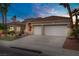 Charming single-story home with a three-car garage, desert landscaping, and a bright red front door at 2257 Lauren Dr, Las Vegas, NV 89134