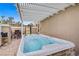 A luxurious hot tub is nestled under a pergola, surrounded by pavers, offering a private outdoor retreat at 2257 Lauren Dr, Las Vegas, NV 89134