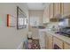 Functional laundry room with ample cabinet space, sink, and washer and dryer at 2257 Lauren Dr, Las Vegas, NV 89134