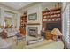Inviting living room featuring a cozy fireplace, custom built-ins, and elegant decor at 2257 Lauren Dr, Las Vegas, NV 89134