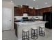Well-equipped kitchen with a center island, granite countertops, and modern black appliances at 2501 Rofrano Pl, Henderson, NV 89044