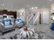 Spacious living room with modern decor, an open staircase, and a glimpse into the kitchen at 2501 Rofrano Pl, Henderson, NV 89044