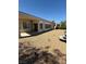 An appealing backyard with desert landscaping, a water feature, and a covered patio providing shade at 2562 Downeyville Ave, Henderson, NV 89052