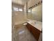 Bathroom featuring a combined shower and tub, sink and tile floors at 2562 Downeyville Ave, Henderson, NV 89052