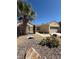 Charming single-story home with desert landscaping, decorative bridge, and a mature palm tree at 2562 Downeyville Ave, Henderson, NV 89052