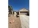 Inviting single-story home with a two-car garage, desert landscaping, and a mature palm tree at 2562 Downeyville Ave, Henderson, NV 89052
