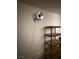 Garage wall with mounted fan, wire shelving and wiring at 2562 Downeyville Ave, Henderson, NV 89052