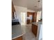 Functional kitchen featuring stainless steel appliances, wood cabinets, and tiled flooring at 2562 Downeyville Ave, Henderson, NV 89052