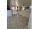 Spacious living area featuring tile flooring, a mirrored wall, and plenty of natural light at 2562 Downeyville Ave, Henderson, NV 89052