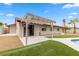 Attractive backyard featuring a covered patio, in-ground pool, and artificial turf at 2620 E Harmon Ave, Las Vegas, NV 89121