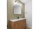 Bathroom featuring a wood vanity with a mirror, modern faucet, and stylish light fixture at 2620 E Harmon Ave, Las Vegas, NV 89121