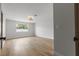 This bright bedroom features wood-look flooring, a modern light fixture, and ample natural light from a window at 2620 E Harmon Ave, Las Vegas, NV 89121