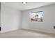 Bright bedroom with neutral carpet and a view of palm trees outside the window at 2620 E Harmon Ave, Las Vegas, NV 89121