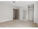 Neutral bedroom featuring a sliding mirrored closet door and an adjacent entrance at 2620 E Harmon Ave, Las Vegas, NV 89121