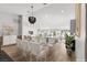 Elegant dining area with a glass-top table, modern chairs, and an open view of the living space at 2620 E Harmon Ave, Las Vegas, NV 89121