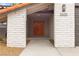 Inviting front entrance with a brick facade, orange double doors, and modern exterior lighting at 2620 E Harmon Ave, Las Vegas, NV 89121